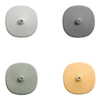 Set of four ceramic dish soap dispensers in gray, light gray, sage green, and soft yellow with smooth, rounded designs.