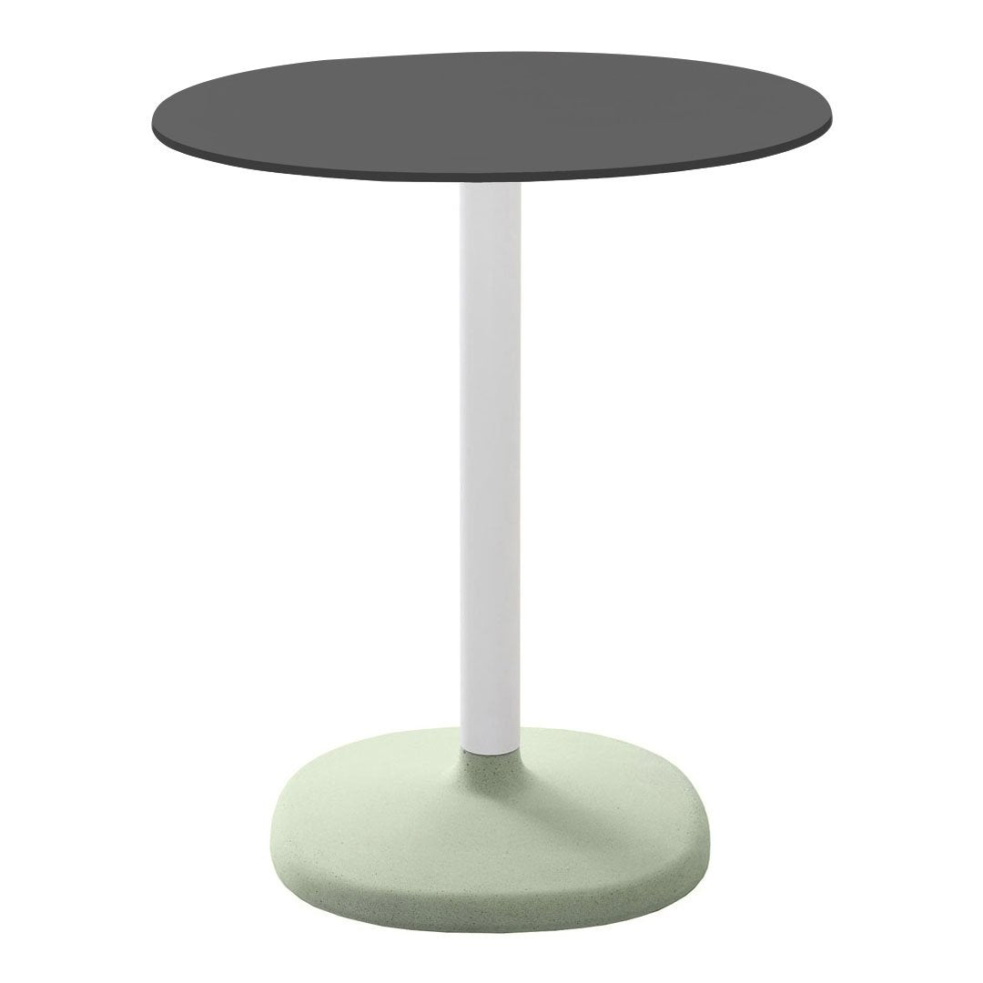 Round table with a sleek black top, white pole, and mint green base, perfect for modern decor.