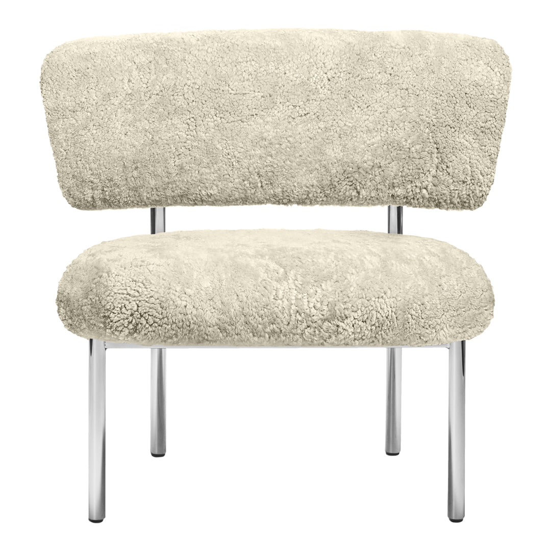 Cream-colored chair with soft, plush texture and sleek chrome legs, showcasing a minimalist design.
