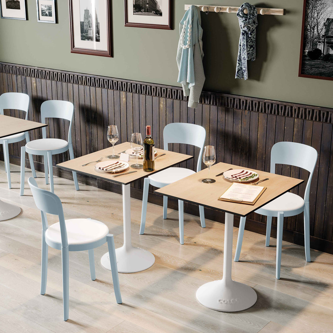Stylish light blue chairs with wooden tables, featuring a modern aesthetic and soft color palette in a chic dining setting.