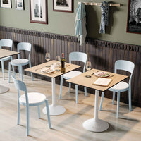 Stylish light blue chairs with wooden tables, featuring a modern aesthetic and soft color palette in a chic dining setting.
