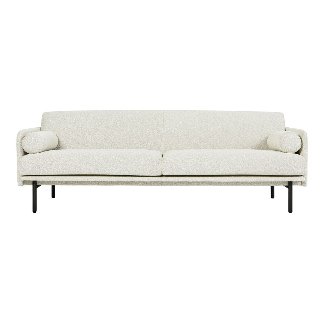 Cream-colored, minimalist sofa with subtle texture and decorative round cushions on each side.