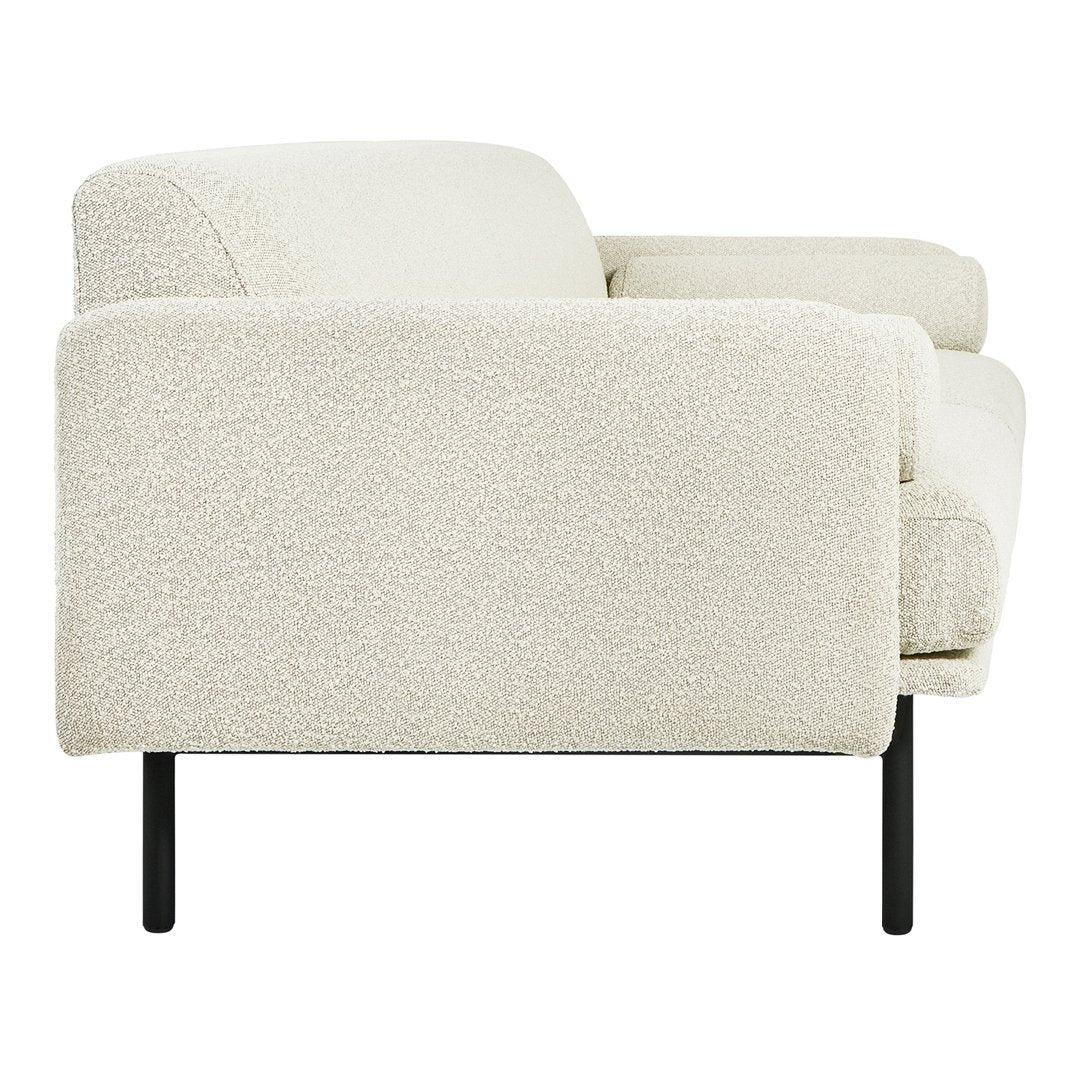 Cozy cream-colored sofa with a textured, boucle fabric and sleek black metal legs, perfect for modern interiors.