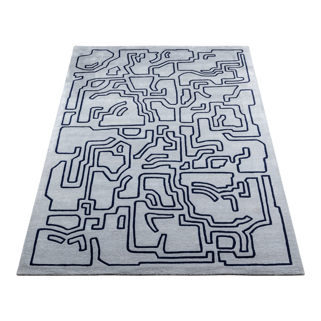 Abstract gray rug with navy blue geometric line pattern, perfect for modern decor.