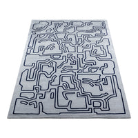 Abstract gray rug with navy blue geometric line pattern, perfect for modern decor.