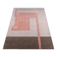 Geometric rug featuring soft pink, beige, and dark brown color blocks with modern abstract patterns.