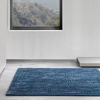 Textured blue area rug featuring geometric patterns, perfect for modern decor.