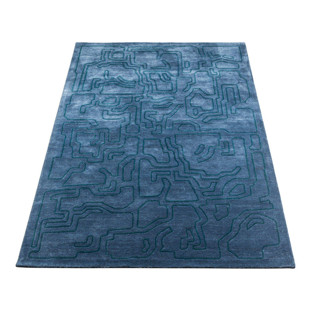 Elegant blue area rug featuring a textured abstract pattern and intricate line design. Perfect for modern decor.