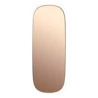Rose gold oval mirror with a sleek, minimalistic design and smooth edges, reflecting a stylish ambiance.