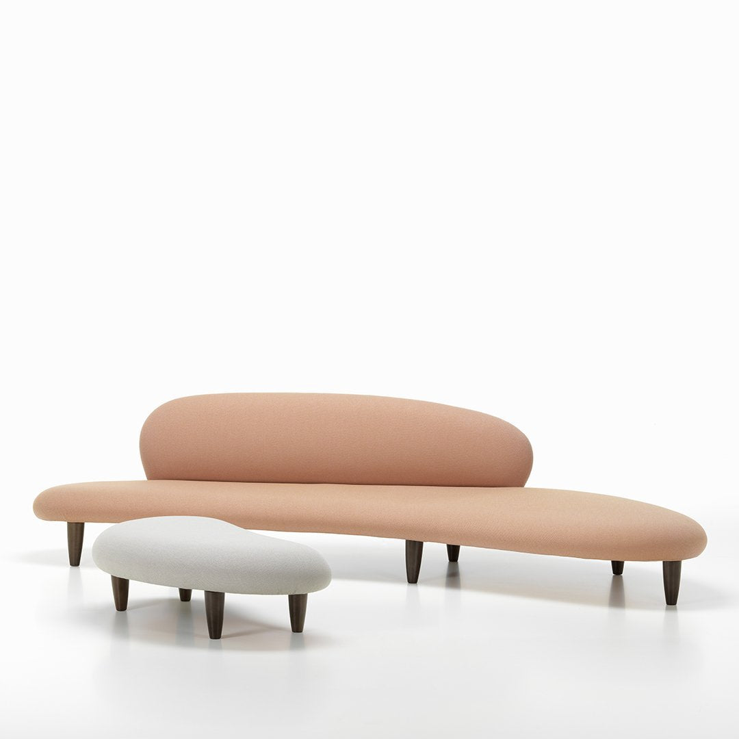 Curved sofa set featuring soft peach and light gray upholstery with natural wood legs, ideal for modern decor.