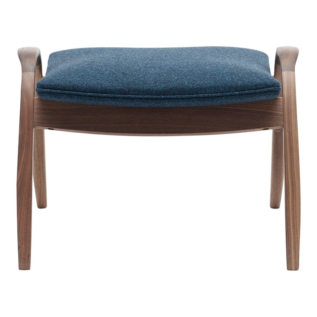 Textured blue upholstery on a sleek wooden frame, featuring a minimalist design with smooth curves.