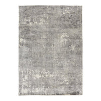 "Rectangular gray rug with subtle patterns and a textured, distressed finish."