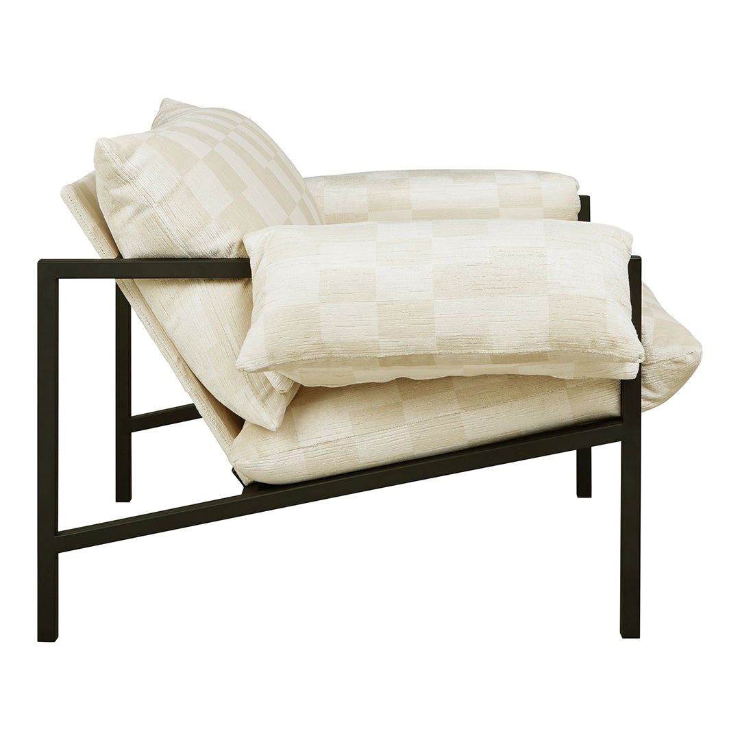 Cream and beige checkered patterned cushions on a modern black-framed chair, perfect for stylish interiors.