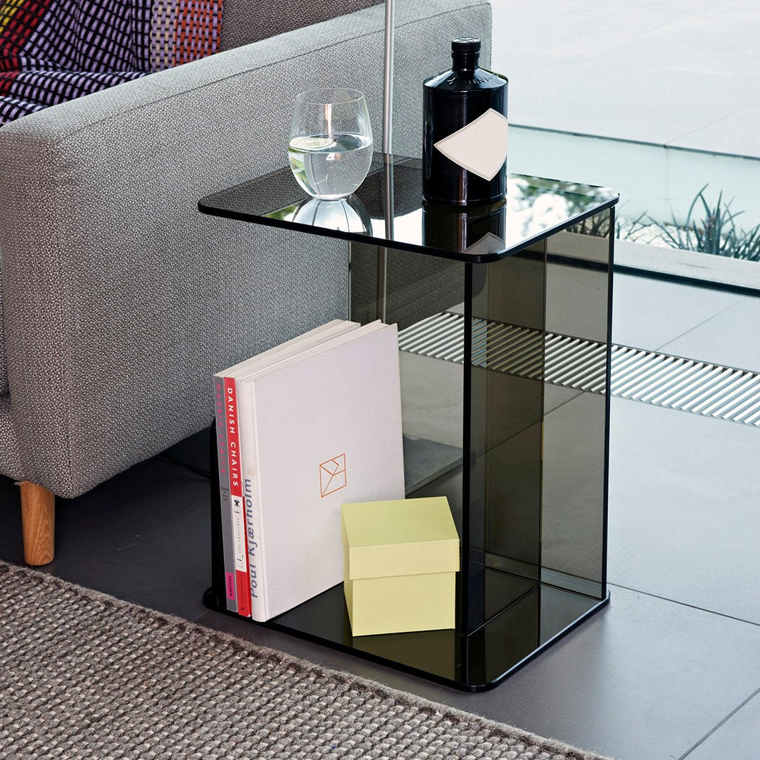 Elegant black glass side table with a minimalist design, featuring a geometric pattern and a sleek, modern finish.