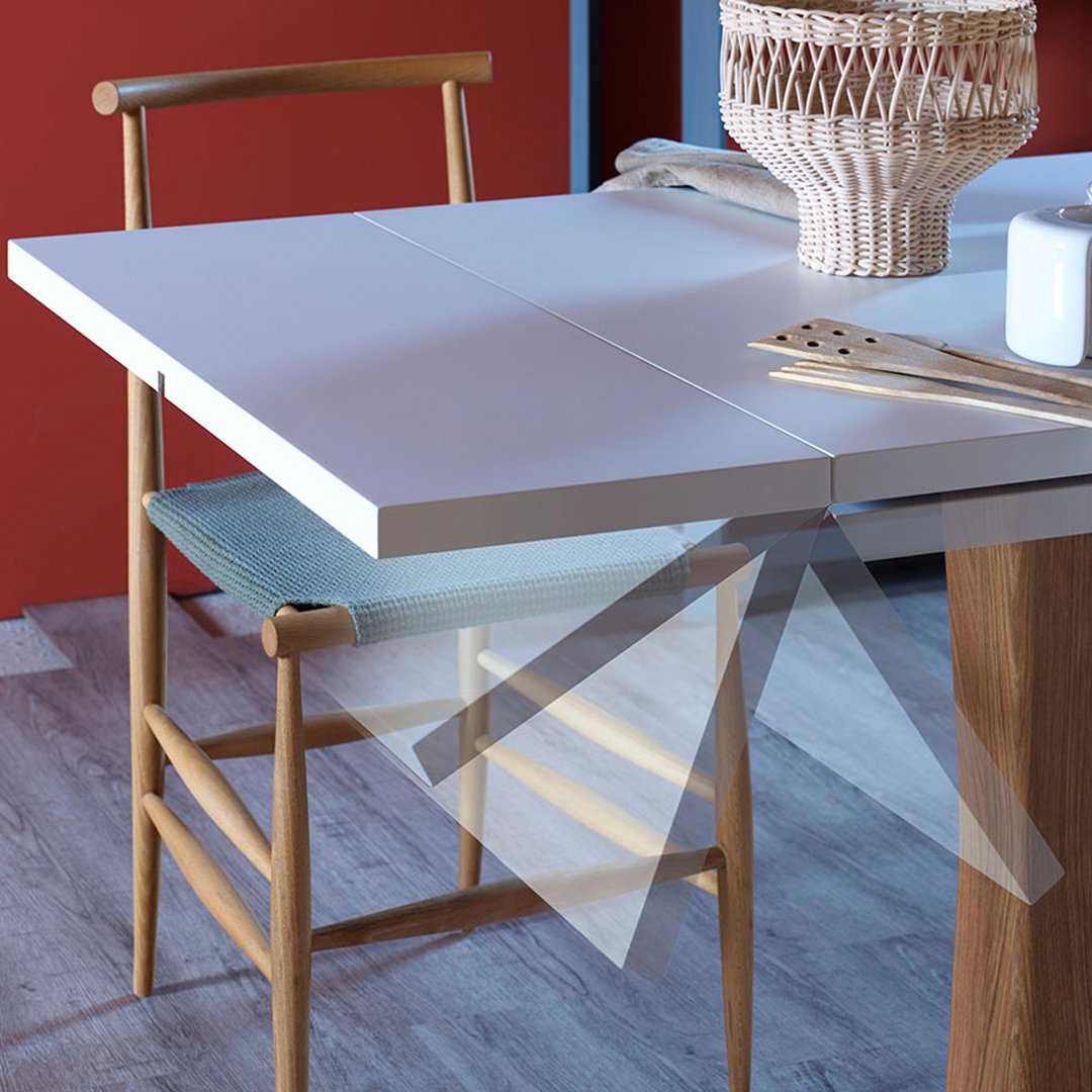 White dining table with a light blue chair, set against a warm red wall, featuring a minimalistic, modern design.