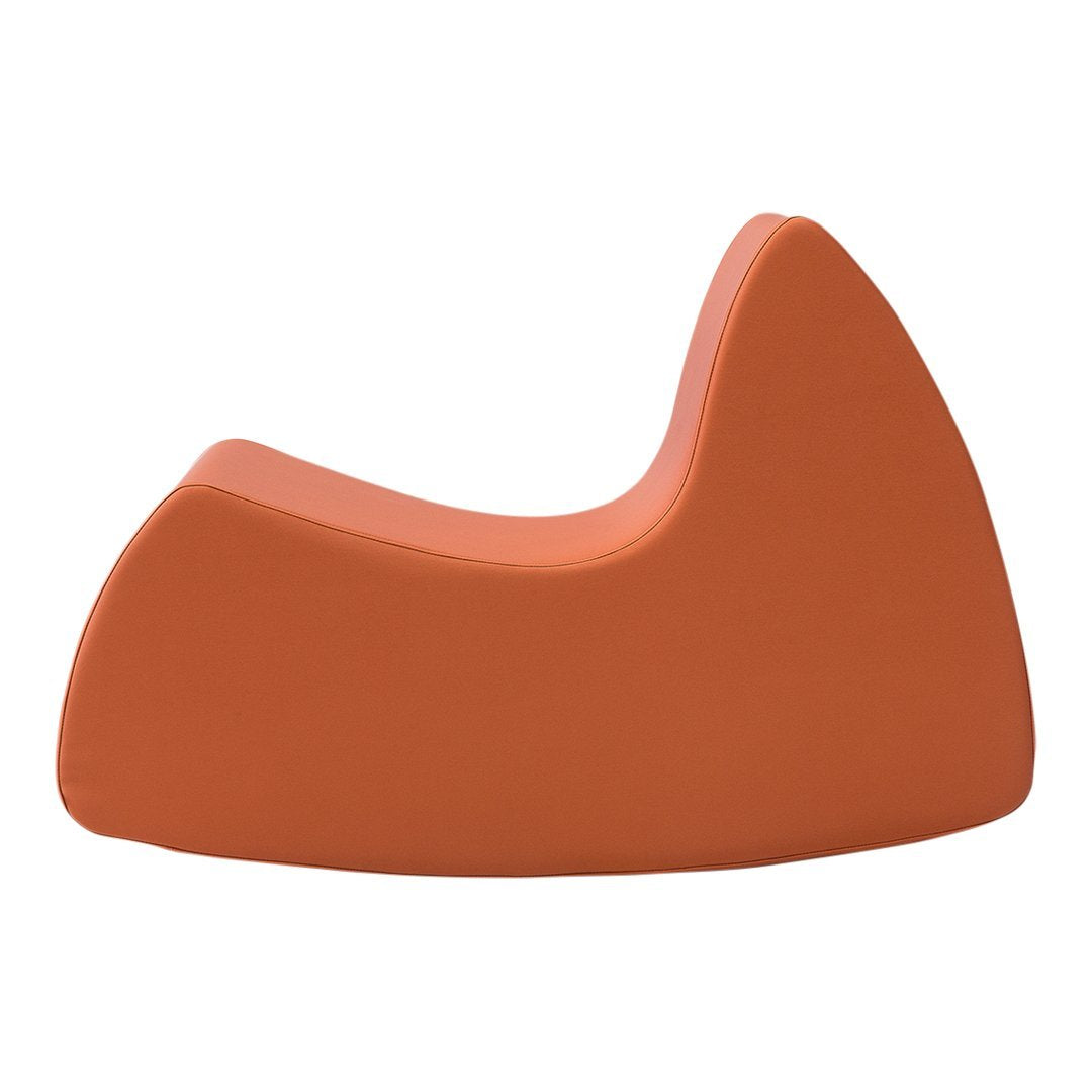 Terra-cotta orange sculptural lounge chair with a smooth, modern design and curved profile. No patterns.