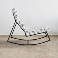 Black and white zigzag patterned rocking chair with a sleek metal frame. Ideal for modern decor.