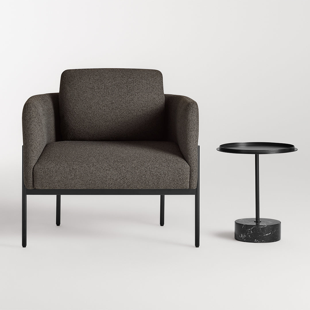 Brown textured armchair with a sleek black metal frame, paired with a minimalist black side table.