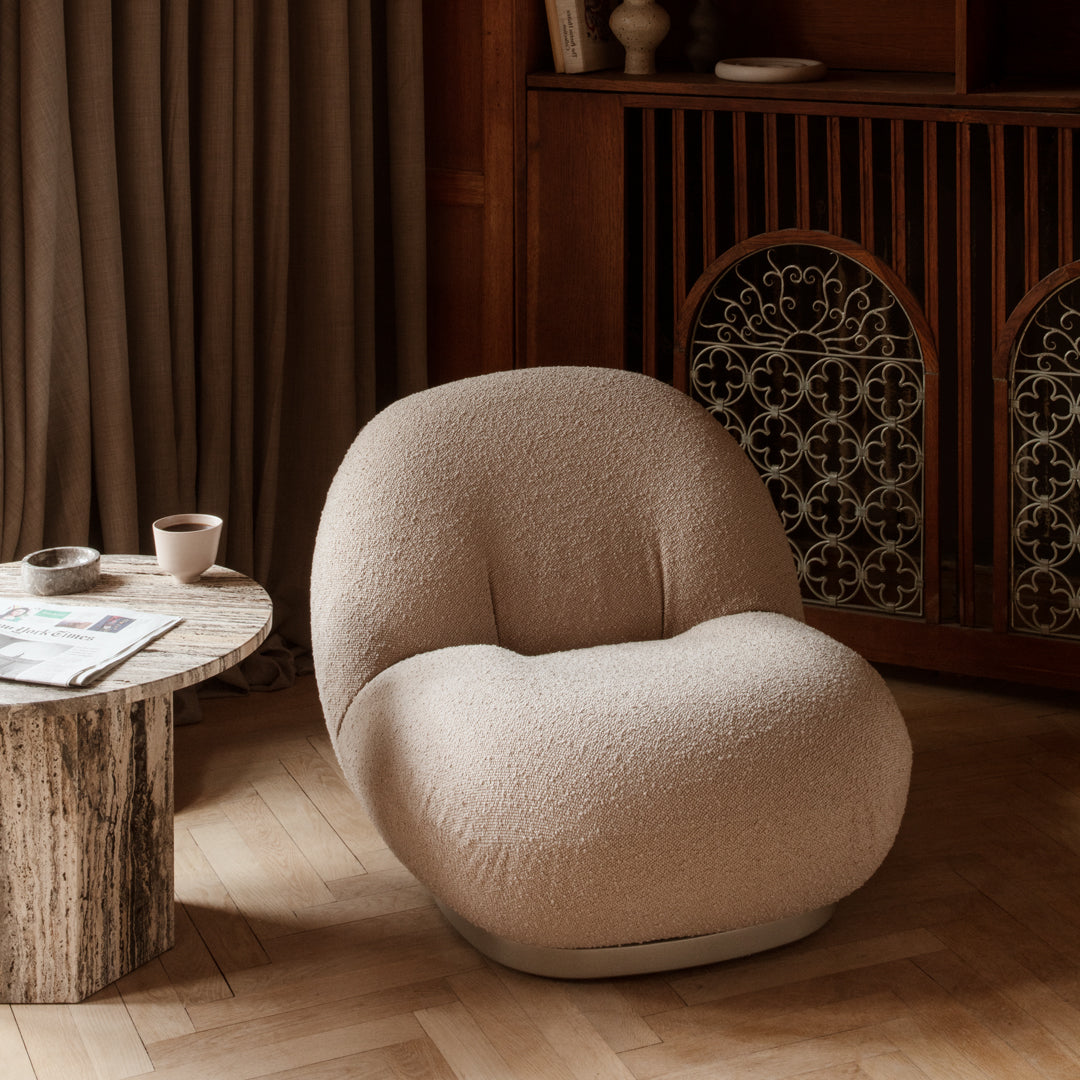 Cozy beige lounge chair with a soft, textured finish, perfect for modern interiors and relaxed settings.
