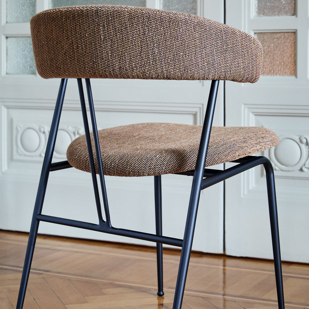 Brown textured upholstery with a sleek black metal frame, featuring a minimalist design for modern interiors.
