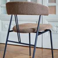 Brown textured upholstery with a sleek black metal frame, featuring a minimalist design for modern interiors.