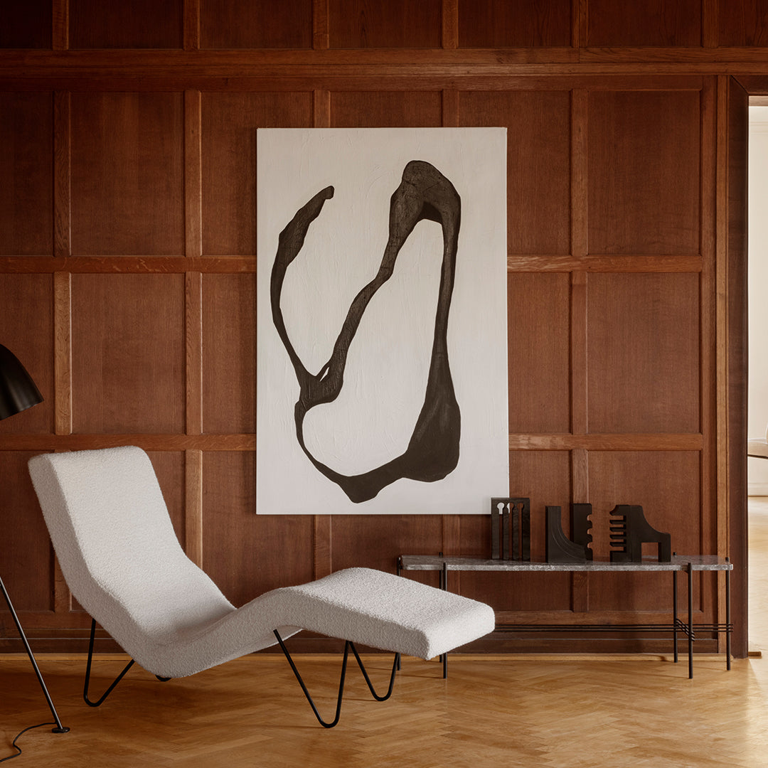 Abstract black lines on a white canvas against a warm wood-paneled background. Modern and minimalist design.