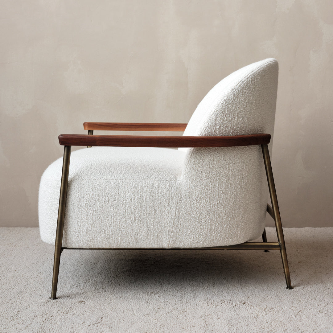 White textured upholstery with natural wood armrests on a sleek metal base, creating a modern and elegant look.
