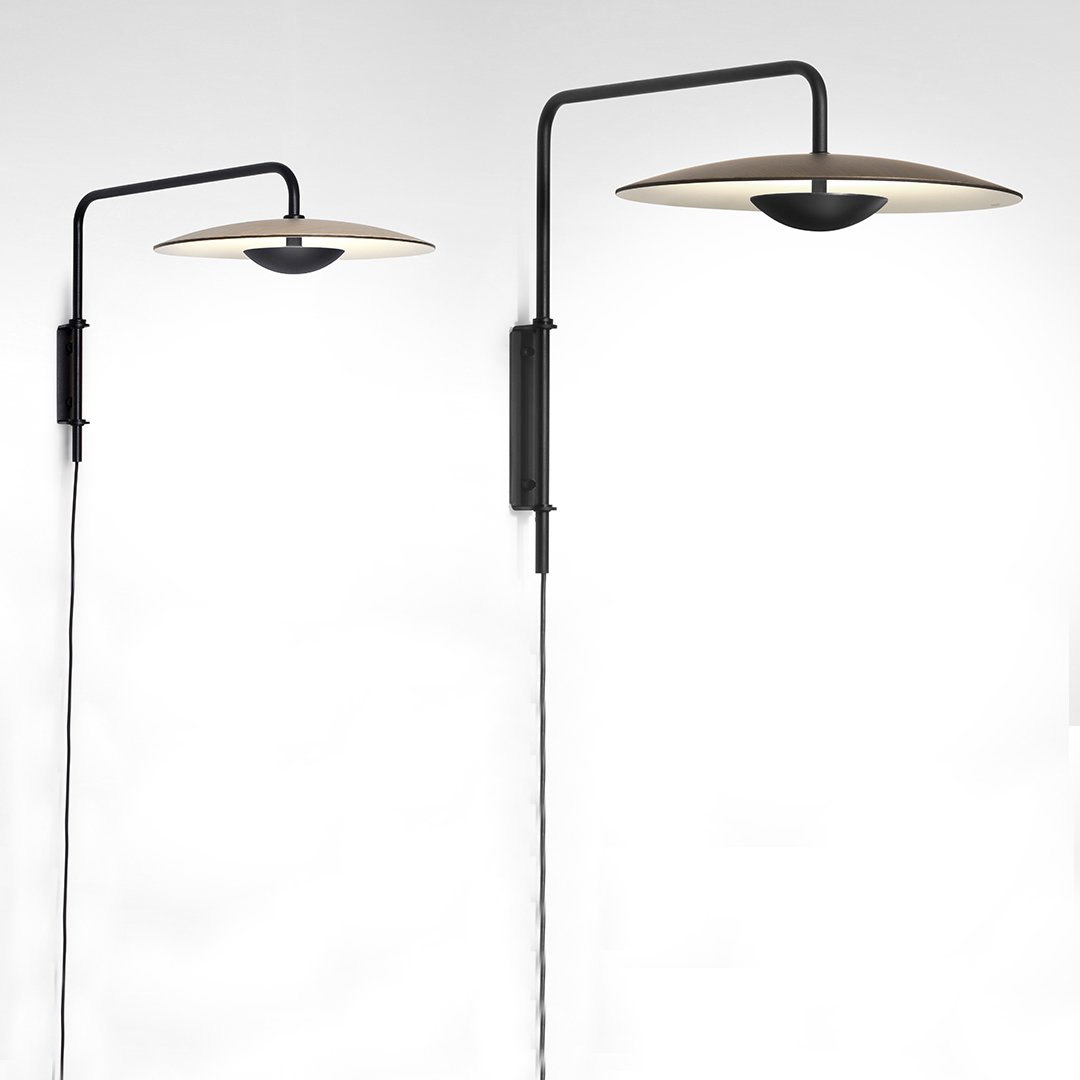 Modern black wall-mounted lamps with sleek metallic shades and warm light. Elegant minimalist design.
