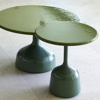 Dual green glossy side tables with sleek, round tops and unique pedestal bases. Perfect for modern decor.