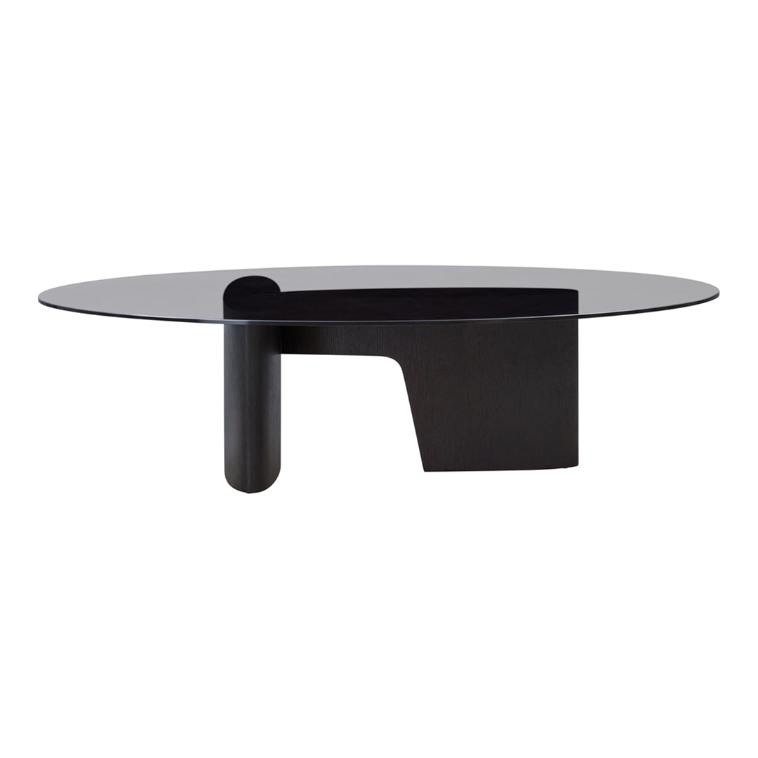 Modern oval coffee table with a sleek black base and a transparent glass top, showcasing minimalist design.