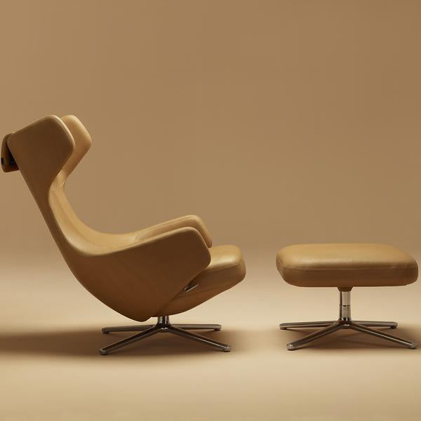 Tan ergonomic chair with sleek curves and matching ottoman on a beige background, showcasing minimalist design.
