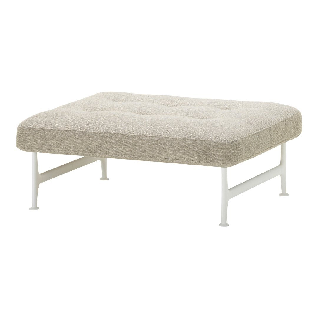 Beige tufted ottoman with a lightweight white metal frame, offering a minimalist and modern design.
