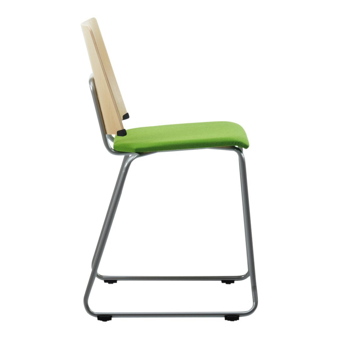 Side view of a sleek chair featuring a green seat, light wood backrest, and a silver metal frame.