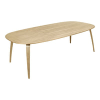 Light oak oval dining table with smooth wood grain and natural finish, featuring minimalist design and tapered legs.
