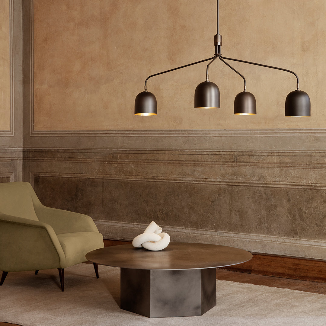 Modern lighting with sleek black and gold fixtures, paired with olive green and warm brown accents in a minimalist setting.