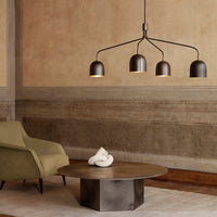Modern lighting with sleek black and gold fixtures, paired with olive green and warm brown accents in a minimalist setting.