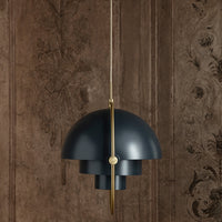 Dark blue pendant light with a sleek curved design, accented by a gold support against a textured brown background.