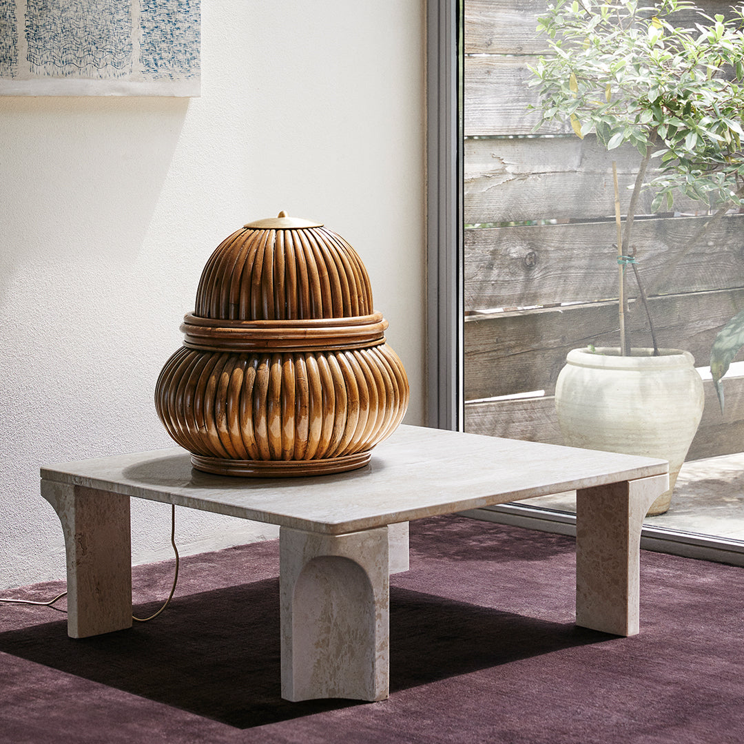 Wooden container with ribbed pattern, warm brown tones, placed on a light stone tabletop against a soft purple carpet.