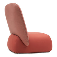 Coral-colored lounge chair with a textured backrest and smooth seat for modern decor.