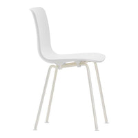 White minimalist chair with smooth, curved surfaces and sleek, light-colored legs. Simple and modern design.