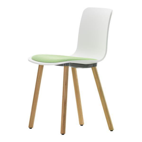White modern chair with green seat cushion and natural wood legs. Minimalist design for a contemporary look.