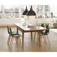 Modern wooden dining table with slate top and green chairs, complemented by black pendant lights and a light wooden floor.