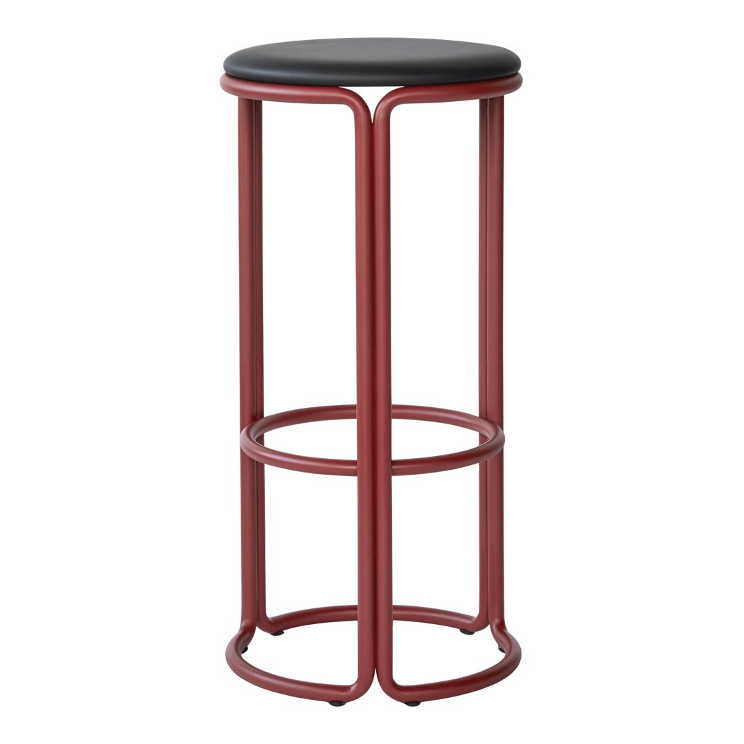 Red metal bar stool with a sleek black seat, featuring a minimalist design and smooth, modern lines.