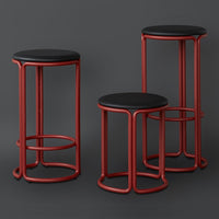 "Set of three modern bar stools with black seats and red metal frames, featuring sleek curved designs."