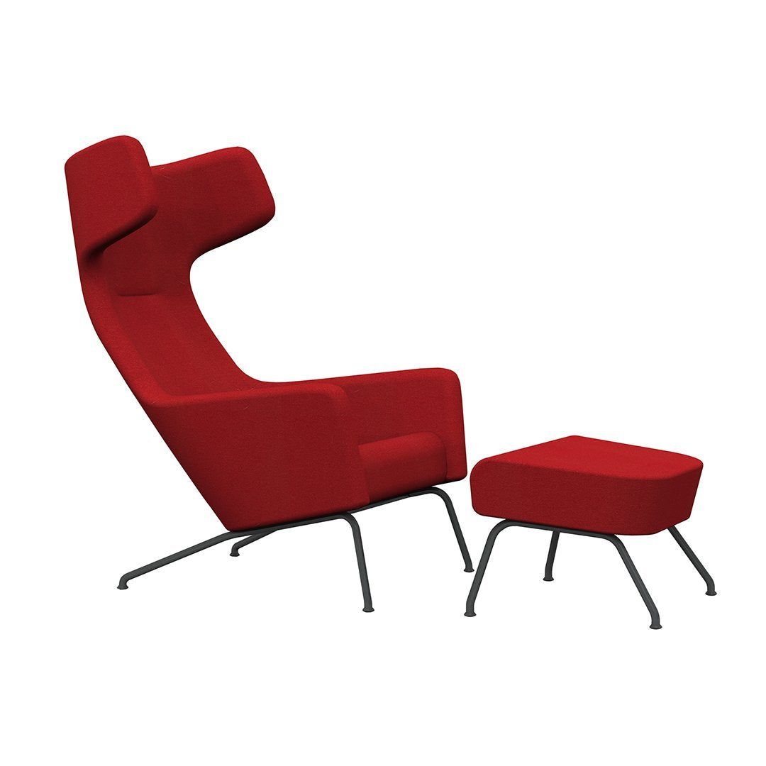 Vibrant red high-back chair with matching ottoman, featuring a sleek, modern design and minimalistic metal legs.