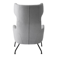 Soft gray upholstered chair with a minimalist design and sleek black metal legs. Simple, elegant, modern aesthetic.