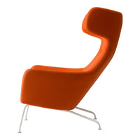 Modern orange armchair with a sleek design and smooth fabric, featuring a unique curved back and metal legs.