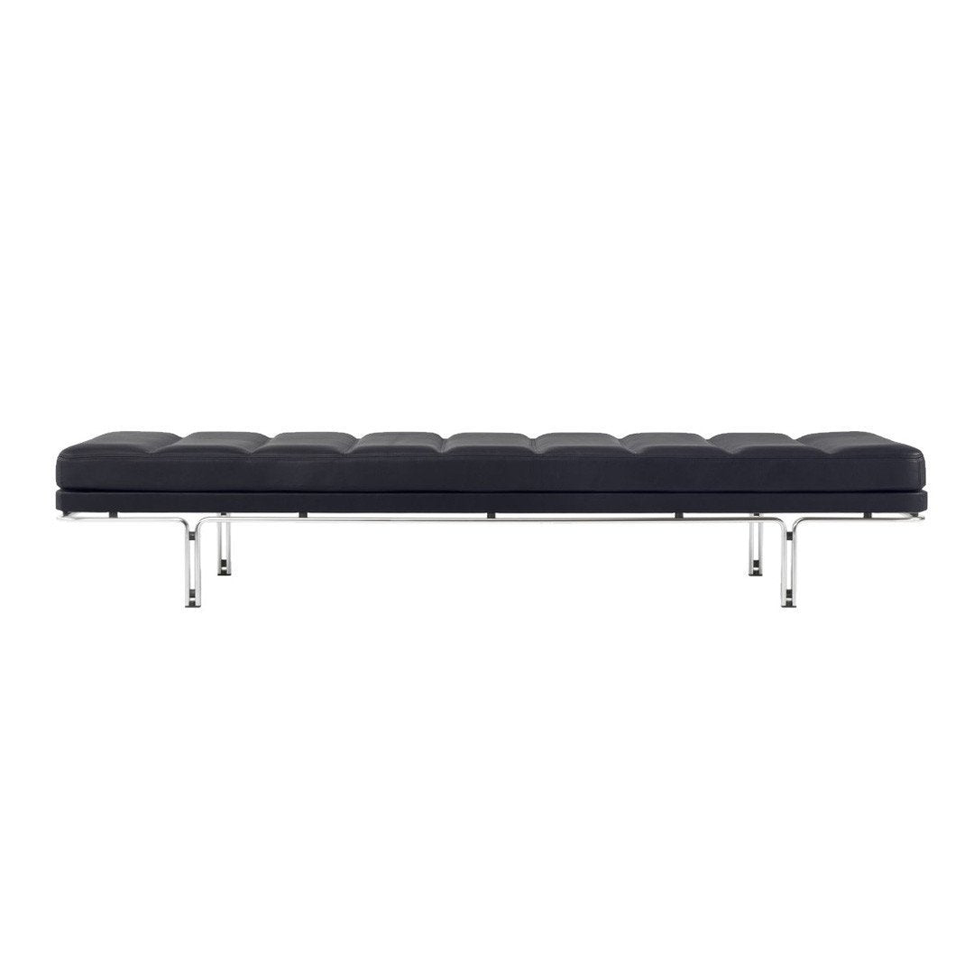 Black leather bench with tufted pattern and sleek chrome legs. Minimalist design adds modern elegance.