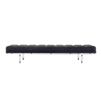 Black leather bench with tufted pattern and sleek chrome legs. Minimalist design adds modern elegance.