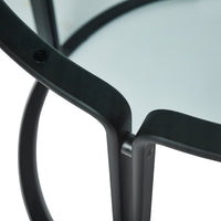 Black metal frame with smooth curved edges and a clear glass tabletop, featuring a minimalist design.